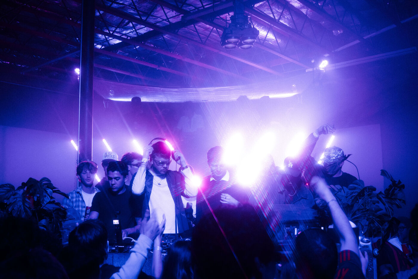 Purple-lit warehouse crowd at a BOOMBA show