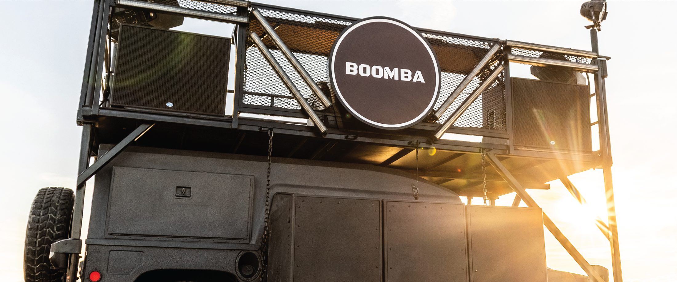 Close-up of the BOOMBA deck and 40-inch sign at golden hour